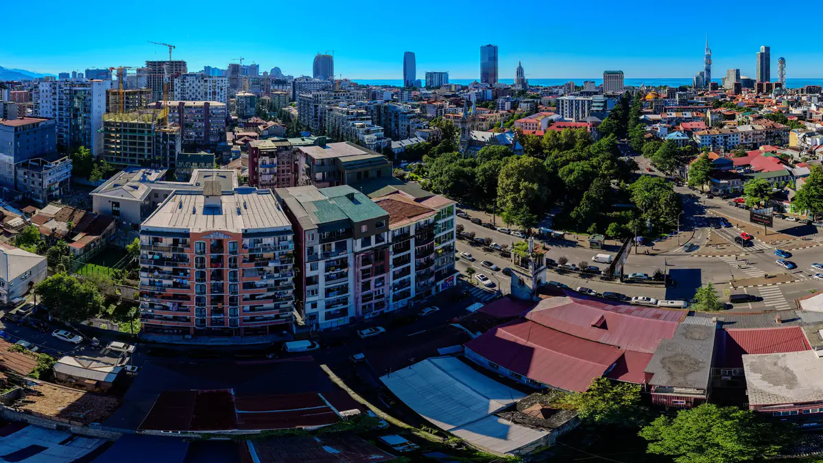 The view from the site at the height of floor 16: the blocks of central Batumi, a park, an early 20th-century tower and the sea on the horizon