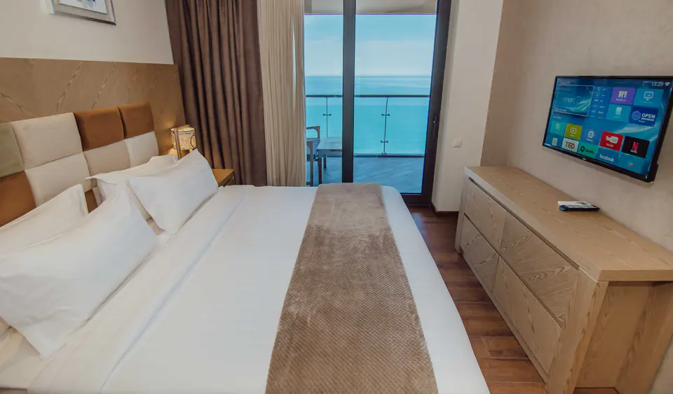 Bedroom of an apartment with a balcony over the sea