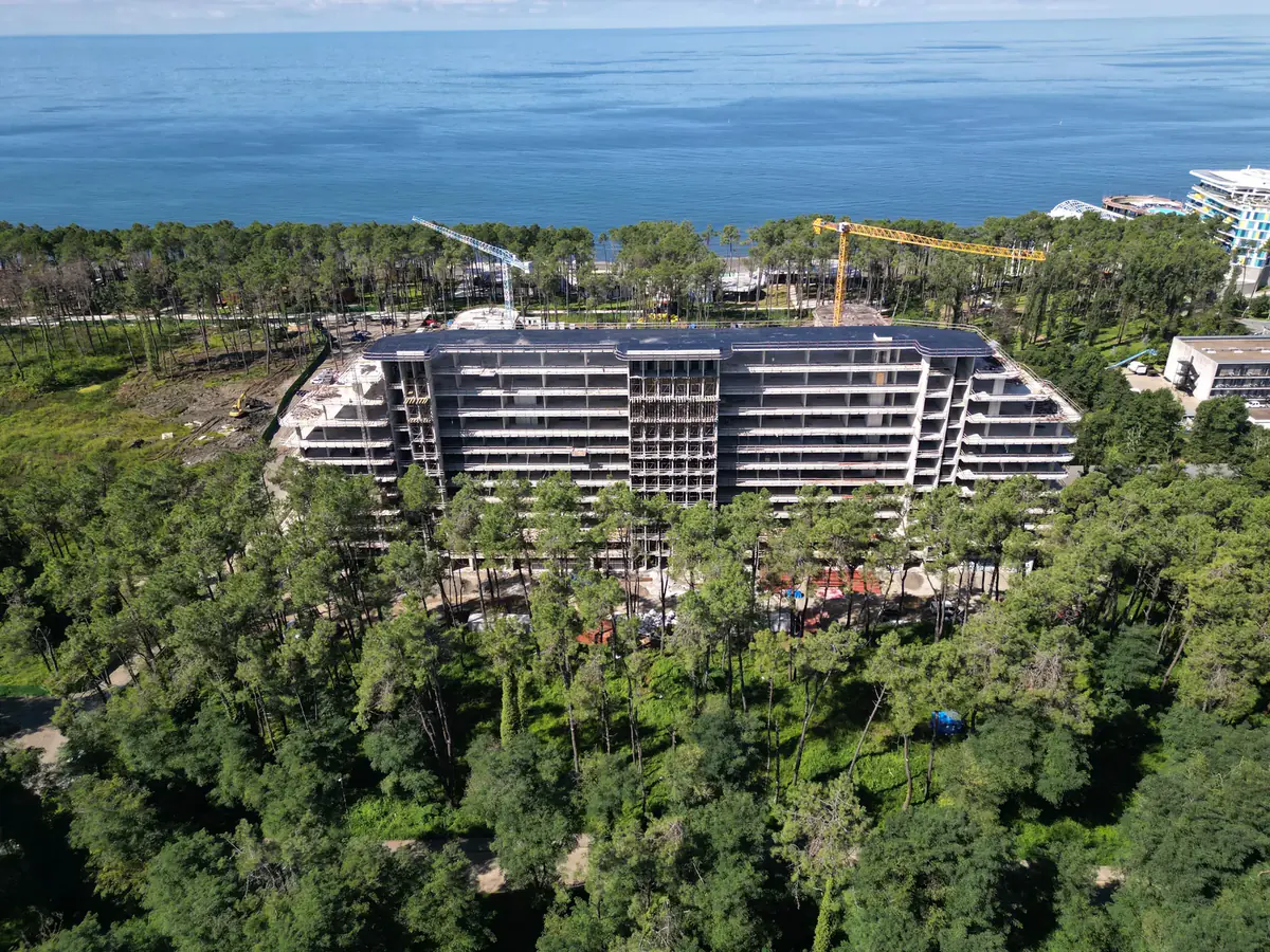 Block A under construction in the pine forest, drone photo of September 2026