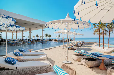 The restaurant terrace of the club and the loungers by the water